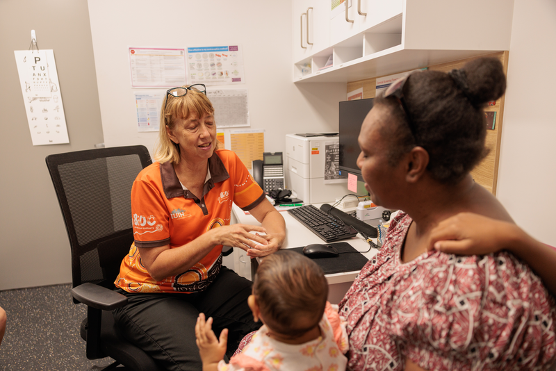 Image of child with parent and clinical staff