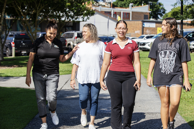 Moreton Bay area photo of four women walking through a local park together, for our Jobs at Moreton ATSICHS page.