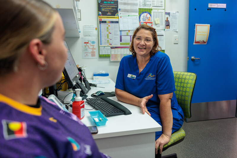 An image of a health worker talking to a patient about MyMedicare